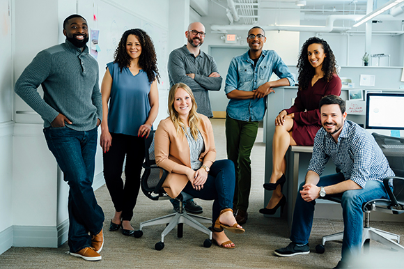 A diverse team photo in an office setting