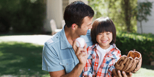 Father teaching son to play baseball