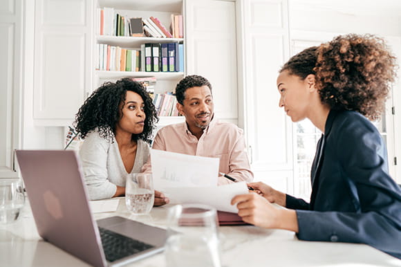 A GenX couple talking with an advisor