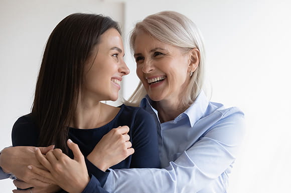Mother and daughter embracing each other