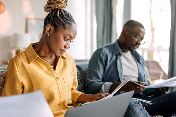 A man and a woman working on their taxes