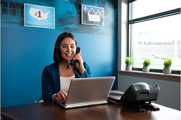 woman working at a desk on the phone